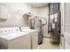 Laundry room with washer, dryer, water heater and HVAC unit at 450 E Ohio St # 106, Indianapolis, IN 46204
