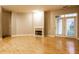 Living room with hardwood floors, fireplace, and access to patio at 450 E Ohio St # 106, Indianapolis, IN 46204