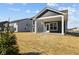Backyard view of home with a covered patio and an expansive, unfinished lawn at 5511 Sienna Ct, Brownsburg, IN 46112
