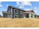 Home's backyard, showing the exterior with a covered patio and large windows at 5511 Sienna Ct, Brownsburg, IN 46112