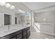 Bathroom with dual vanity, tile floors, large mirror, and walk-in tiled shower at 5511 Sienna Ct, Brownsburg, IN 46112