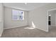 Bright bedroom featuring neutral walls and carpet, and a large window for natural light at 5511 Sienna Ct, Brownsburg, IN 46112
