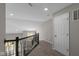 Upstairs hallway with natural light, plush carpeting and a black metal railing at 5511 Sienna Ct, Brownsburg, IN 46112