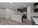 Modern kitchen boasting an island, stylish cabinetry, and stainless steel appliances, seamlessly integrated into the open floor plan at 5511 Sienna Ct, Brownsburg, IN 46112