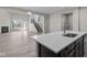 Bright, open-concept kitchen with a large island, modern appliances, and seamless flow into the adjacent living area at 5511 Sienna Ct, Brownsburg, IN 46112