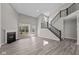 Bright living area with a cozy fireplace, soaring staircase, and hardwood floors, creating an inviting ambiance at 5511 Sienna Ct, Brownsburg, IN 46112
