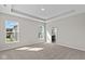 Bright main bedroom featuring two windows, neutral walls, and en suite bathroom at 5511 Sienna Ct, Brownsburg, IN 46112