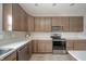 Modern kitchen with stainless steel appliances and light brown cabinets at 6250 Bales Dr, Plainfield, IN 46168
