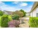 Serene backyard oasis with stone path, birdbath, and mature trees and shrubbery at 7259 Registry Dr, Indianapolis, IN 46217