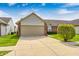 Charming single-story home featuring a brick facade, two-car garage and a well-manicured front yard at 7259 Registry Dr, Indianapolis, IN 46217