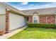 Lovely home with brick accents, lush green lawn, walkway, and a two car attached garage at 7259 Registry Dr, Indianapolis, IN 46217
