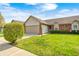 Inviting single-story home with green lawn, neat landscaping and a two-car garage at 7259 Registry Dr, Indianapolis, IN 46217