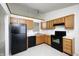 Kitchen with oak cabinets and black appliances at 7259 Registry Dr, Indianapolis, IN 46217