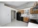 Kitchen with oak cabinets, black appliances, and window at 7259 Registry Dr, Indianapolis, IN 46217