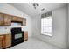 Kitchen with oak cabinets, black appliances, and window at 7259 Registry Dr, Indianapolis, IN 46217