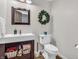 Powder room with pedestal sink and decorative wreath at 740 S County Road 775 W, Coatesville, IN 46121