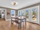 Bright dining room with wooden table, bench seating, and access to deck at 740 S County Road 775 W, Coatesville, IN 46121