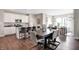 Modern kitchen with white cabinets, an island, and a dining table at 7538 Allesley Dr, Avon, IN 46123