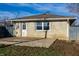 Exterior rear view of house with a concrete patio and stone facade, extending the living space outdoors at 8415 E 10Th St, Indianapolis, IN 46219