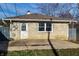 Rear view of the house with stone siding and a concrete patio, offering a private outdoor space at 8415 E 10Th St, Indianapolis, IN 46219