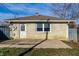 View of the backyard featuring the detached garage, concrete patio, and fencing at 8415 E 10Th St, Indianapolis, IN 46219
