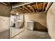 Unfinished basement with laundry and storage at 8415 E 10Th St, Indianapolis, IN 46219