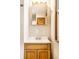 Bathroom features a wood vanity and medicine cabinet at 8415 E 10Th St, Indianapolis, IN 46219