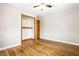 Hardwood floors and neutral walls in this bedroom at 8415 E 10Th St, Indianapolis, IN 46219