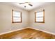 Bright bedroom with hardwood floors and two large windows at 8415 E 10Th St, Indianapolis, IN 46219