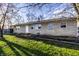 Well-kept stone-faced single-story home with healthy green grass and a pleasant, welcoming appearance at 8415 E 10Th St, Indianapolis, IN 46219