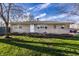 Charming single-story home featuring a stone facade, bright white door, and a well-maintained lawn at 8415 E 10Th St, Indianapolis, IN 46219