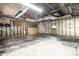 Unfinished garage interior with concrete floor and exposed walls at 8415 E 10Th St, Indianapolis, IN 46219