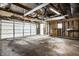 Unfinished garage with double white doors and exposed walls at 8415 E 10Th St, Indianapolis, IN 46219