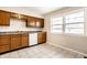 Eat-in kitchen featuring wood cabinets and tiled floors at 8415 E 10Th St, Indianapolis, IN 46219