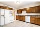 Bright kitchen with wood cabinets, tiled floor, and modern appliances at 8415 E 10Th St, Indianapolis, IN 46219