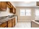 Kitchen with wood cabinets and tile floor at 8415 E 10Th St, Indianapolis, IN 46219