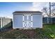 Charming backyard shed with white trim and double doors, nestled in a well-maintained yard at 8415 E 10Th St, Indianapolis, IN 46219