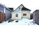 Rear view of tan house with snow, showing a boarded-up window at 952 Udell St, Indianapolis, IN 46208