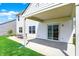 Exterior shows a covered back patio perfect for outdoor dining, with a view of the lawn at 977 Capricorn Dr, Franklin, IN 46131