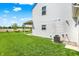 Side view of the backyard highlighting the lawn and the side of the white vinyl sided house at 977 Capricorn Dr, Franklin, IN 46131