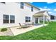 View of the white house featuring a patio area and green backyard with table and chairs at 977 Capricorn Dr, Franklin, IN 46131