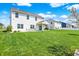 Green and spacious backyard of a white house with a patio and dining area at 977 Capricorn Dr, Franklin, IN 46131