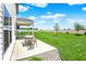 Backyard patio with lawn, plants and view of field in the distance on a sunny day at 977 Capricorn Dr, Franklin, IN 46131