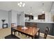 Well-lit dining area flows to a kitchen space, featuring a simple wood table set at 977 Capricorn Dr, Franklin, IN 46131