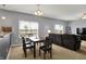 Open-concept dining area with a table, seating, and a view into the adjacent living room at 977 Capricorn Dr, Franklin, IN 46131