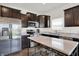 Contemporary kitchen with stainless steel appliances, dark cabinetry and marble countertops at 977 Capricorn Dr, Franklin, IN 46131