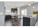Modern kitchen with dark cabinets, stainless steel appliances, and a center island at 977 Capricorn Dr, Franklin, IN 46131