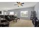Bright living room with plush carpeting, a large window, and comfortable seating area at 977 Capricorn Dr, Franklin, IN 46131