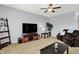 Inviting living room featuring a comfortable brown sofa and modern entertainment center at 977 Capricorn Dr, Franklin, IN 46131