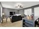 Well-lit living room with carpet flooring, fan, media center, and stylish furniture at 977 Capricorn Dr, Franklin, IN 46131